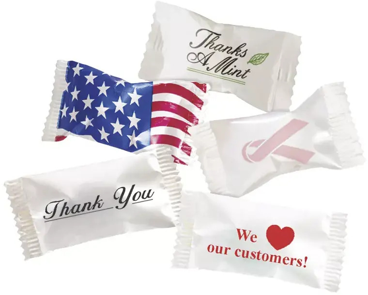 A variety of individually wrapped buttermints featuring different professional and holiday wrapper designs