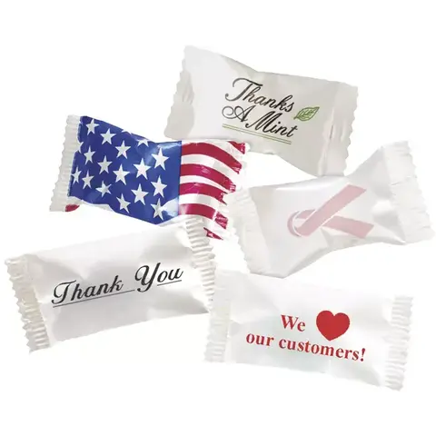 A variety of individually wrapped buttermints featuring different professional and holiday wrapper designs