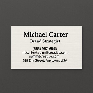 Custom natural white linen business cards printed with raised ink (black only) on the front side