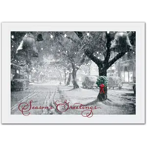 Business holiday cards with a single wreath portrayed on a snowy tree in a black and white snow-covered street