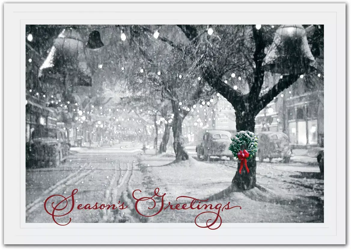 Business holiday cards with a single wreath portrayed on a snowy tree in a black and white snow-covered street
