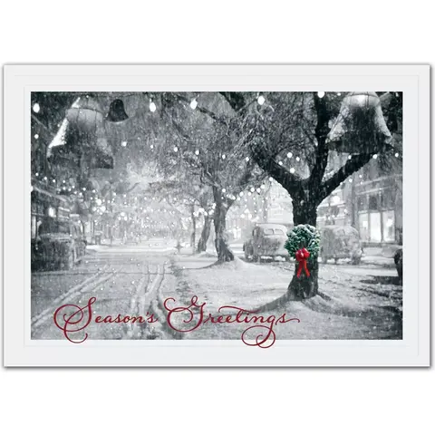 Business holiday cards with a single wreath portrayed on a snowy tree in a black and white snow-covered street