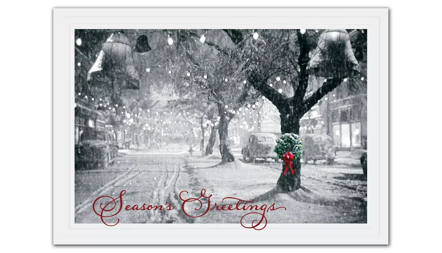 Business holiday cards with a single wreath portrayed on a snowy tree in a black and white snow-covered street