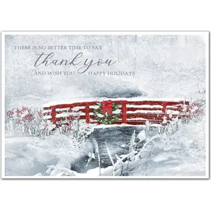 Business holiday card with a thankful greeting surrounded by snow and a red bridge
