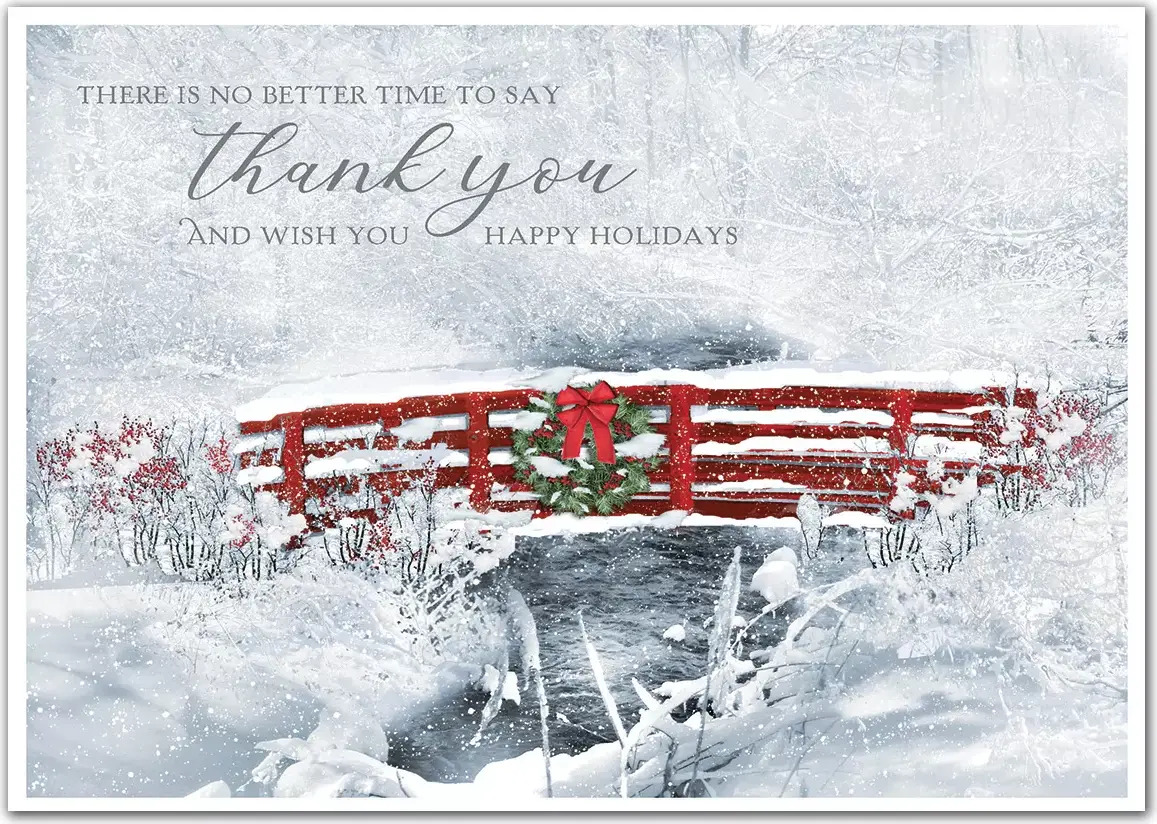 Business holiday card with a thankful greeting surrounded by snow and a red bridge