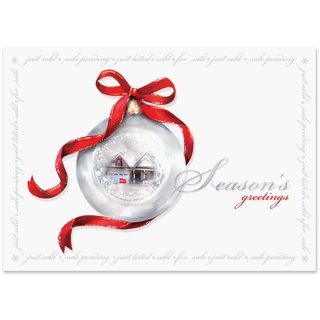 Real estate holiday greeting card featuring a silver ornament with a home inside, red ribbon accents, and a Season's Greetings message.