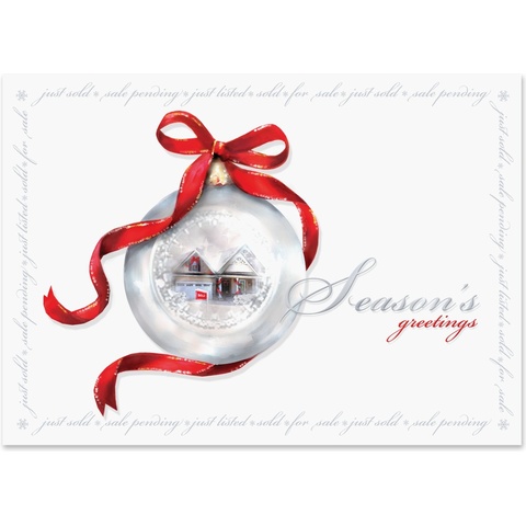Real estate holiday greeting card featuring a silver ornament with a home inside, red ribbon accents, and a Season's Greetings message.