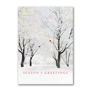 Season’s Greetings card with shimmering snowy trees and red cardinals in a winter forest