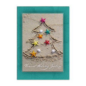 Warm holiday greetings card featuring a Christmas tree drawn in sand with colorful starfish and seashells
