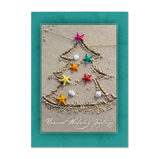 Warm holiday greetings card featuring a Christmas tree drawn in sand with colorful starfish and seashells