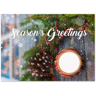 Season's Greetings holiday card featuring a festive ornament, evergreen branches, pinecone accents, and gentle snowfall