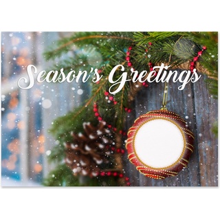 Season's Greetings holiday card featuring a festive ornament, evergreen branches, pinecone accents, and gentle snowfall