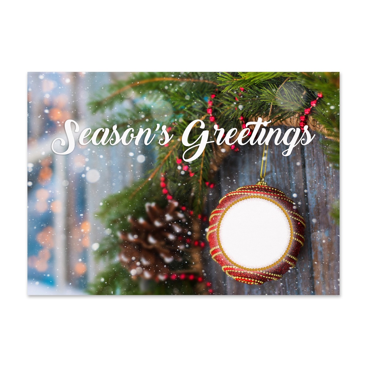 Season's Greetings holiday card featuring a festive ornament, evergreen branches, pinecone accents, and gentle snowfall
