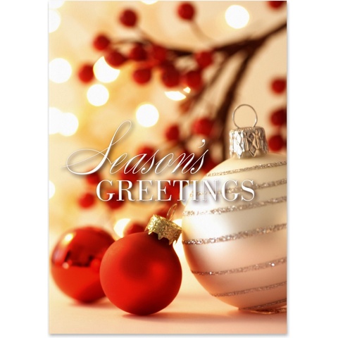 Elegant holiday greeting card featuring red and silver Christmas ornaments with warm glowing lights and festive berries
