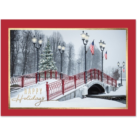 Holiday greeting card featuring a snow-covered red bridge, decorated Christmas tree, vintage lampposts, and a peaceful winter landscape