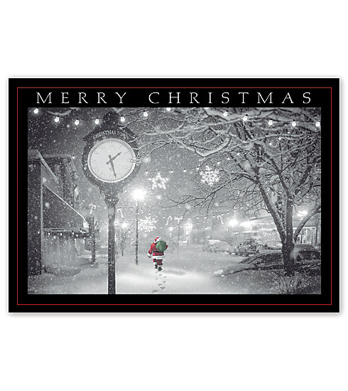 Santa walking through the park on a snowy night adorns this beautiful card.