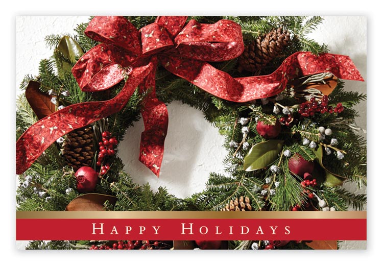 Christmas postcard with wreath covered by big red bow and red ornaments with pine cones.