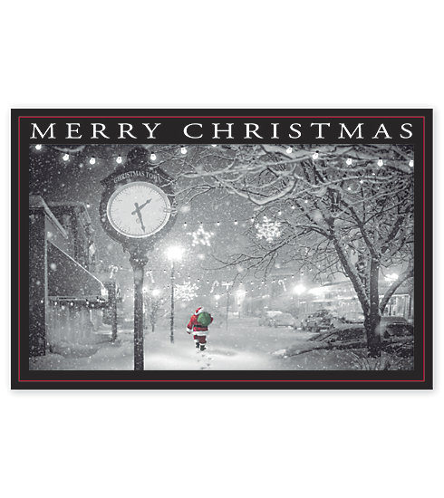 Santa walking through the park on a snowy night adorns this beautiful card.